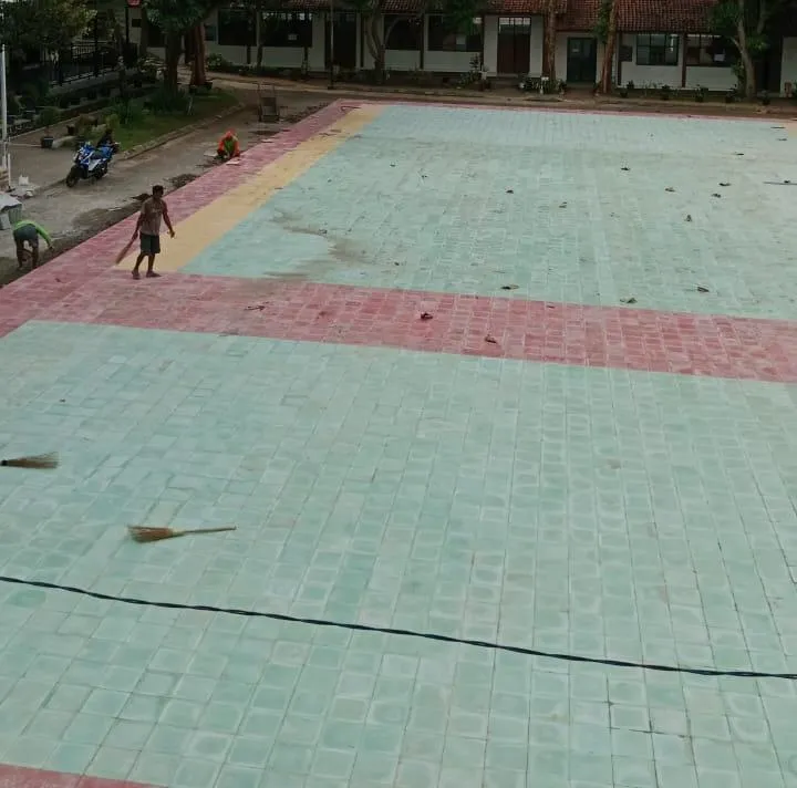 Pemasangan guiding block ubin pada lapangan sekolah